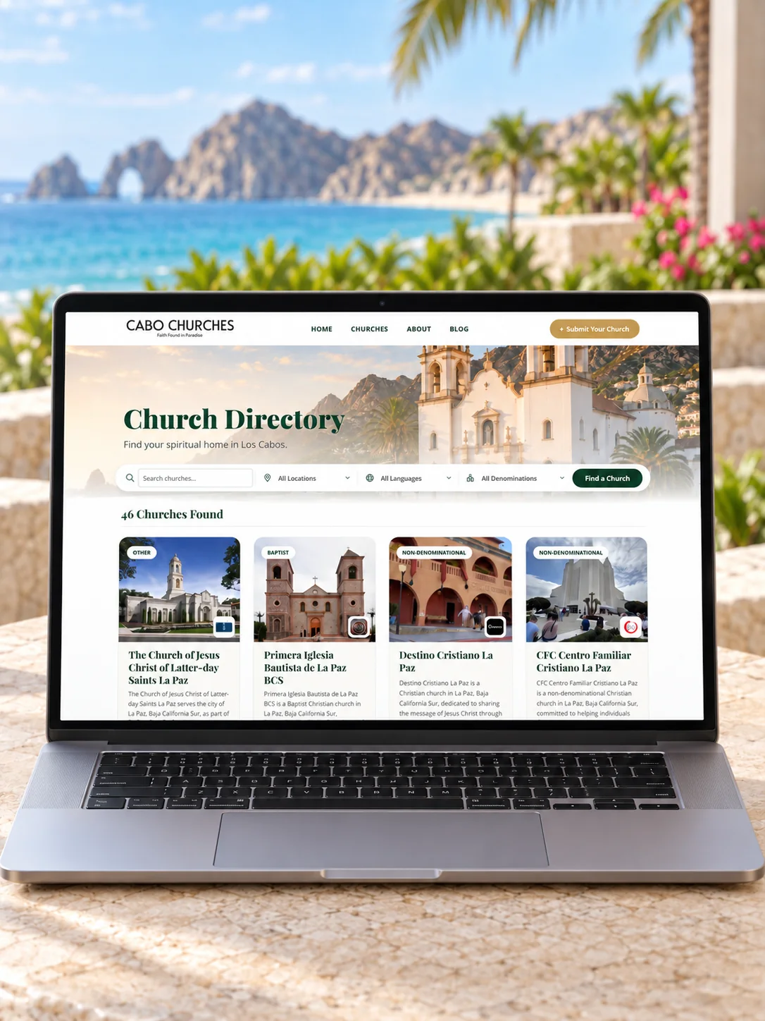 The Cabo Churches directory on a laptop overlooking Cabo San Lucas — search, filters, and church cards